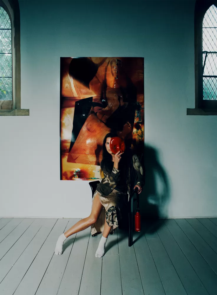 A photograph of Harley Weir sat in her converted church in Faversham