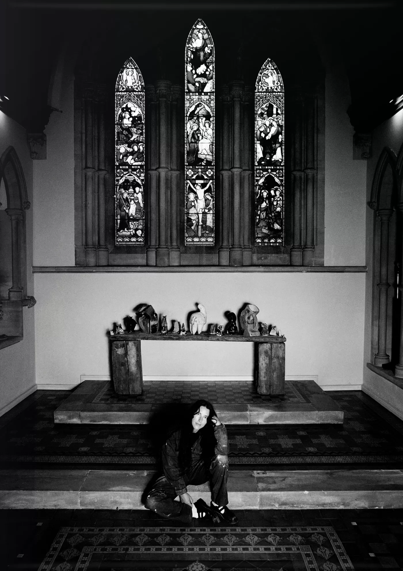 A black and white photograph of Harley Weir inside her converted church in Faversham