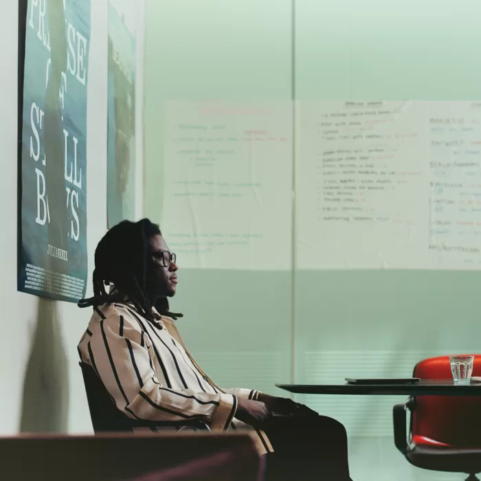 A photograph of Julianknxx sat at a desk in his studio