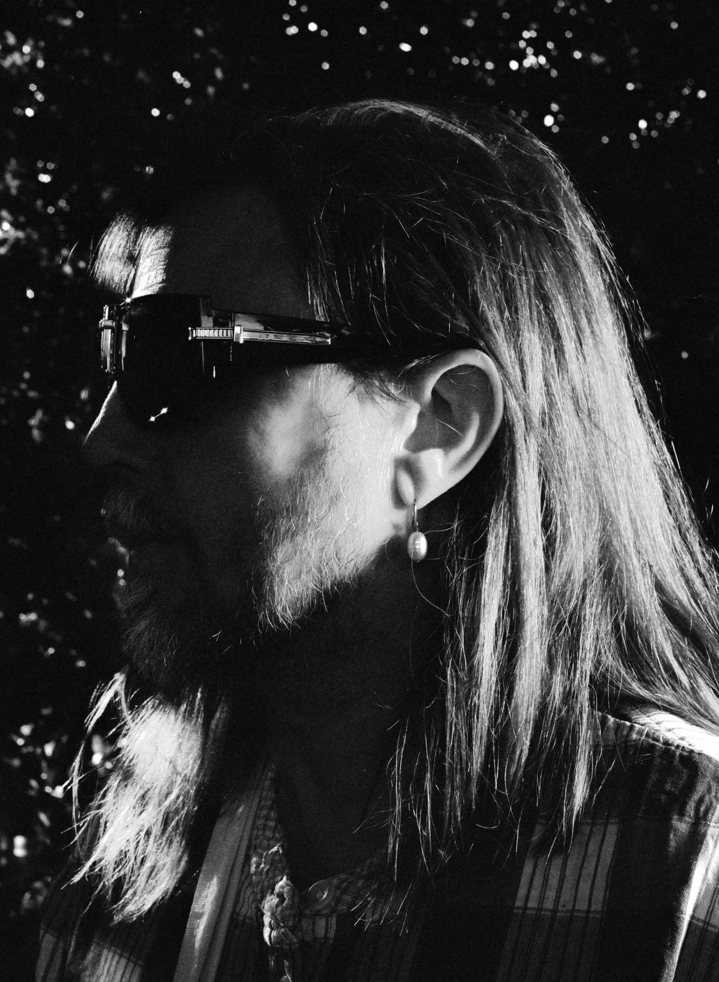 A close-up black and white photograph of Mark Leckey at Alexandra Palace Park, London