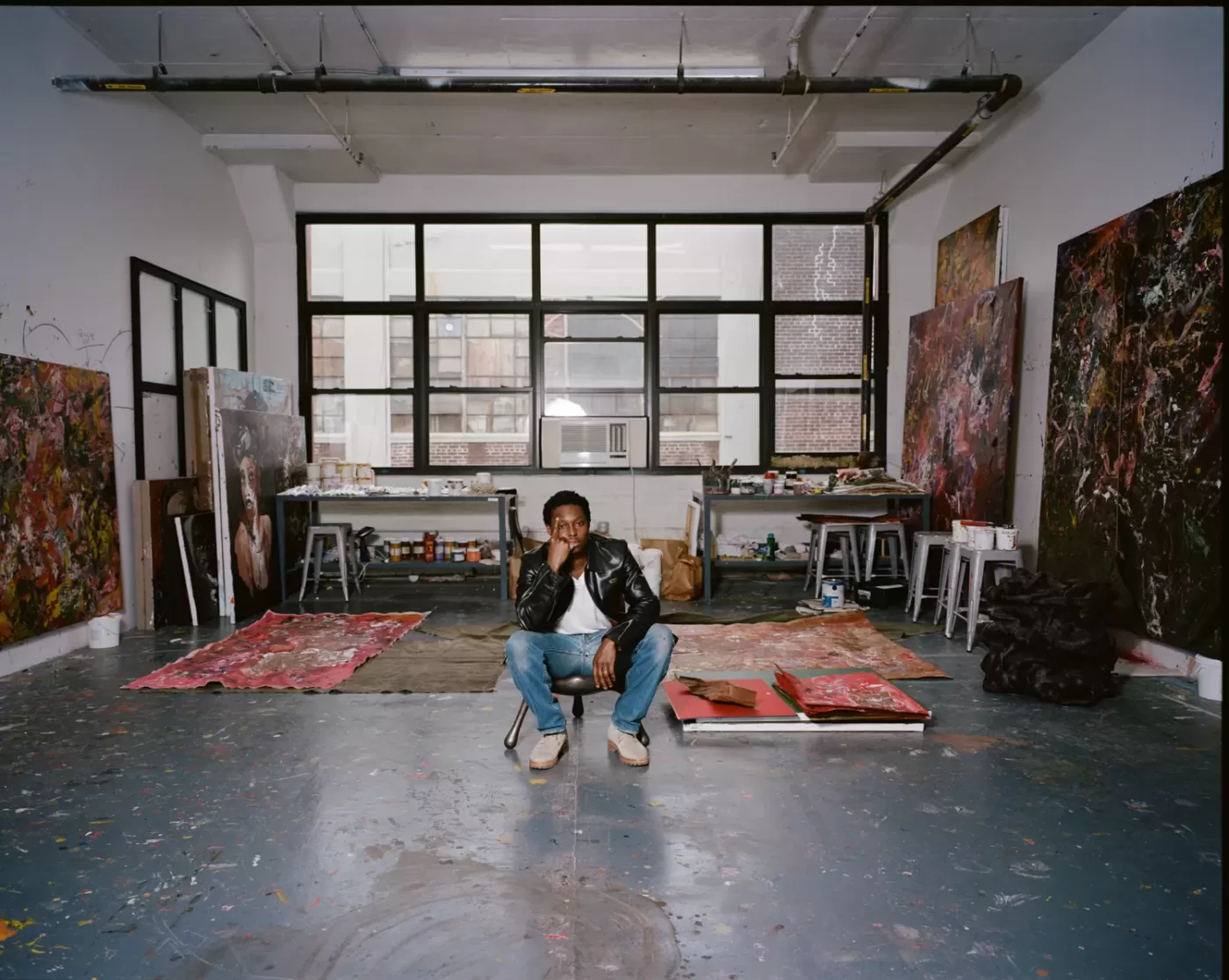 A photograph of Reginald Sylvester II sat in his studio