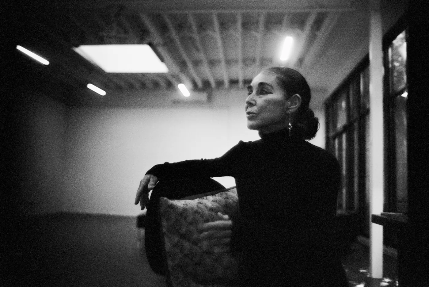 A black and white photograph of Shirin Neshat in her Brooklyn studio