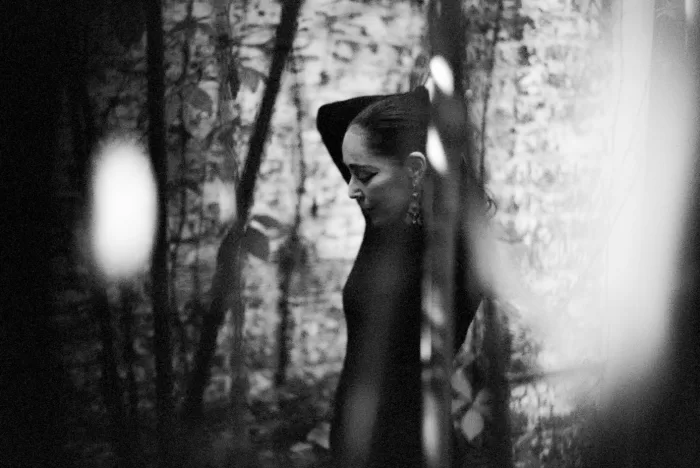 A black and white photograph of Shirin Neshat