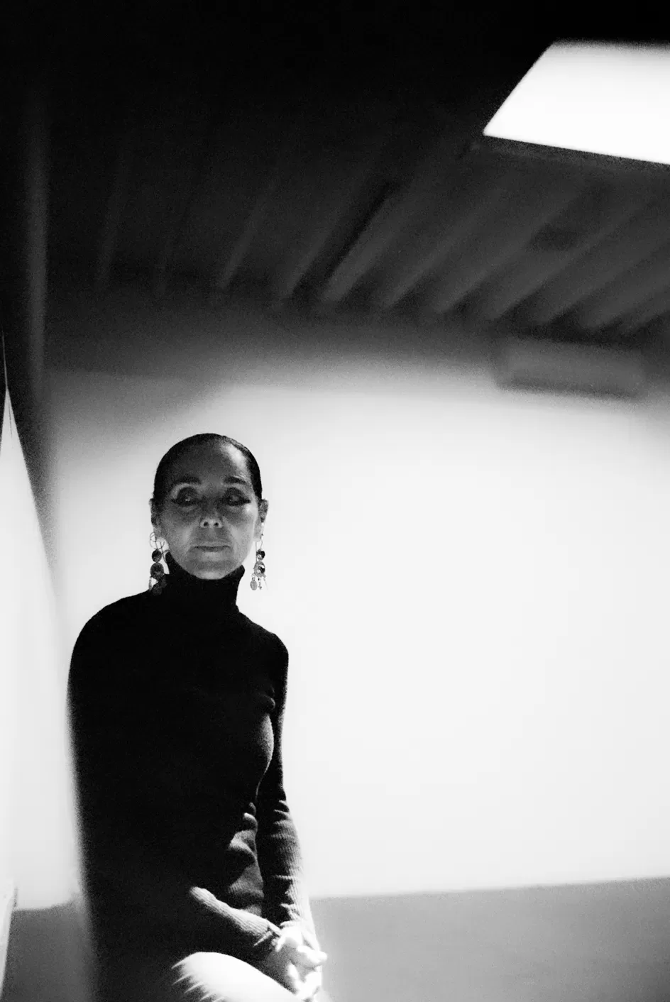 A black and white photograph of Shirin Neshat in her Brooklyn studio