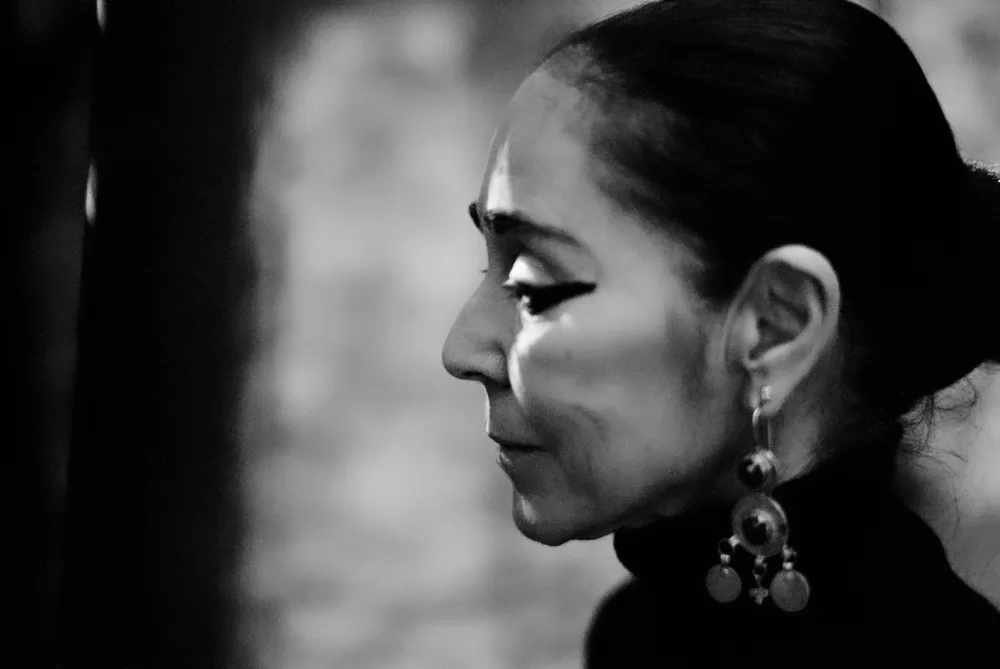 A black and white close-up portrait of Shirin Neshat