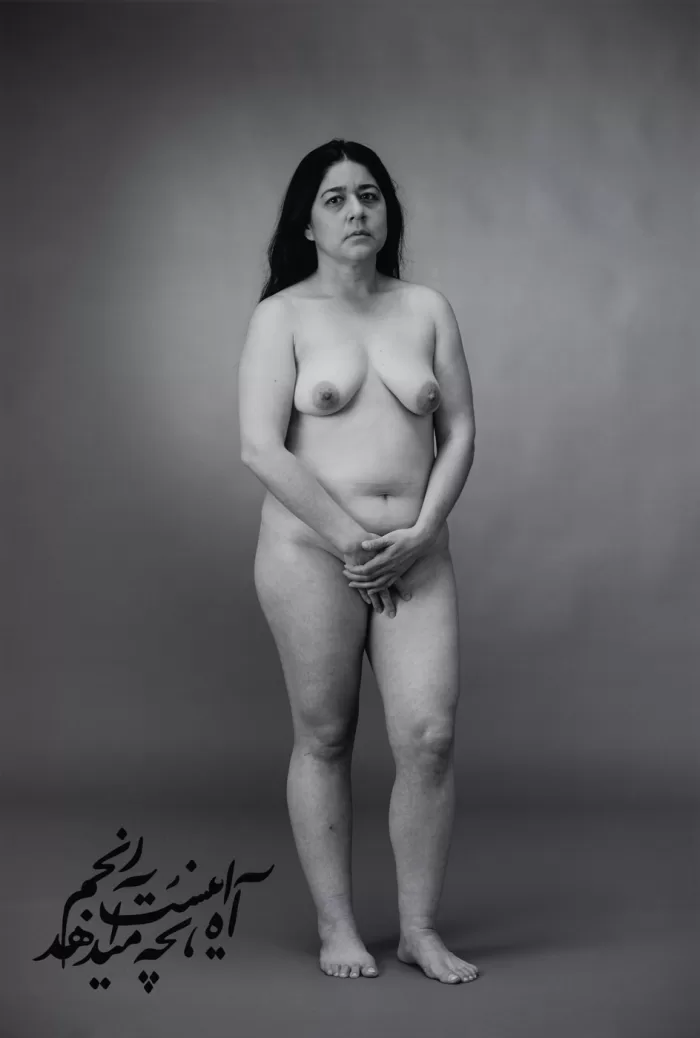 A black and white portrait of a naked woman from 'The Fury' series by Shirin Neshat