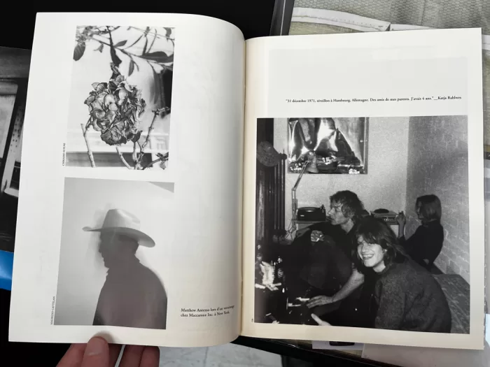 A photograph of a double-page spread from a photobook featuring a collection of black white photographs