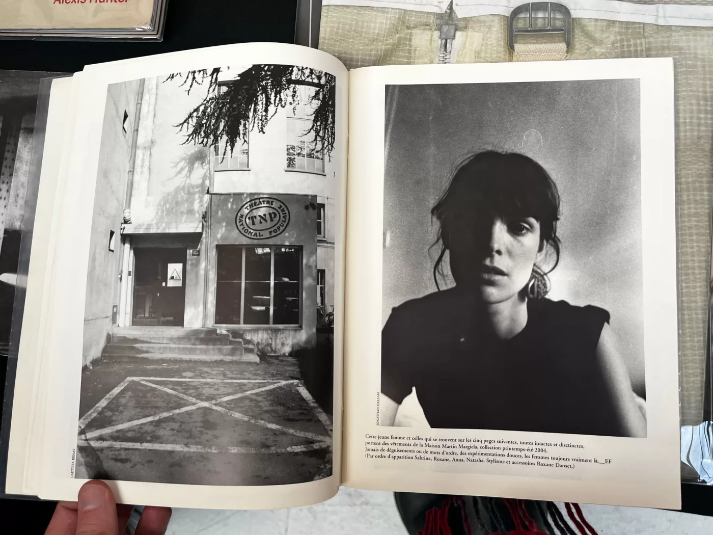 A photograph of a double-page spread from a photobook featuring black and white photographs of a shop front and a portrait of a woman