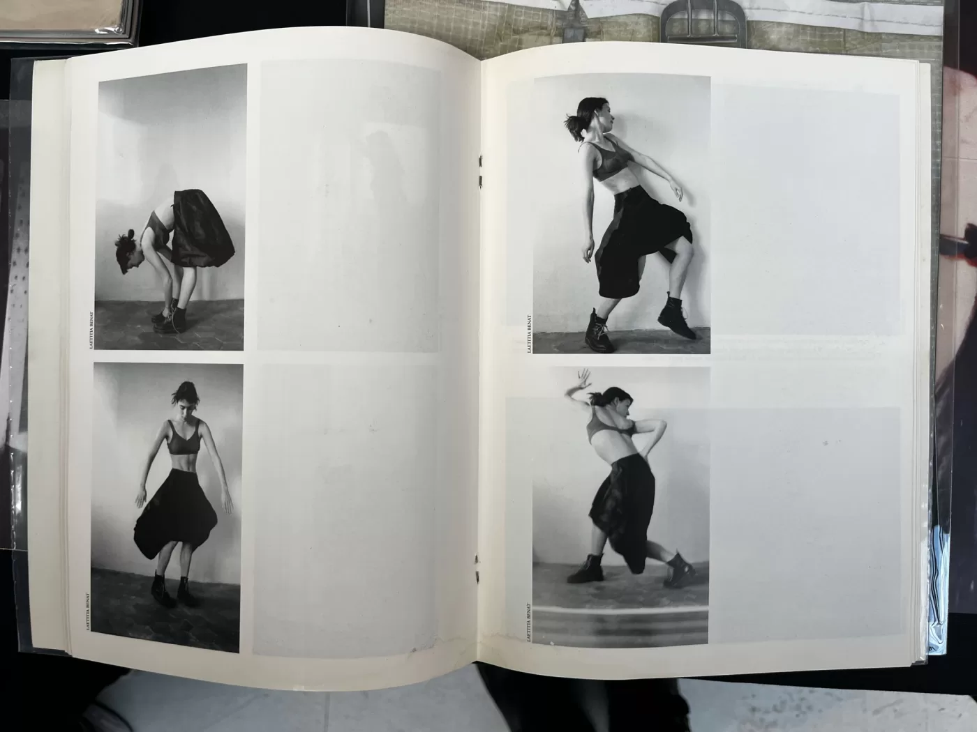 A photograph of a double-page spread from a photobook featuring four black and white photographs of a woman dancing