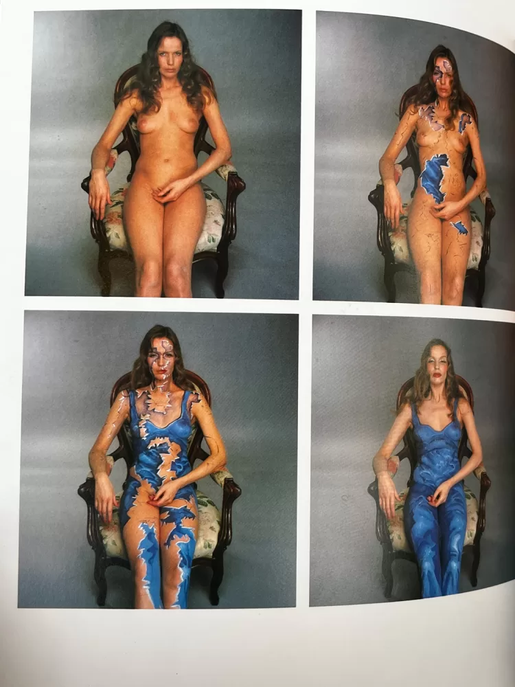 A photograph of a page from a photography book picturing a woman posing wearing body paint