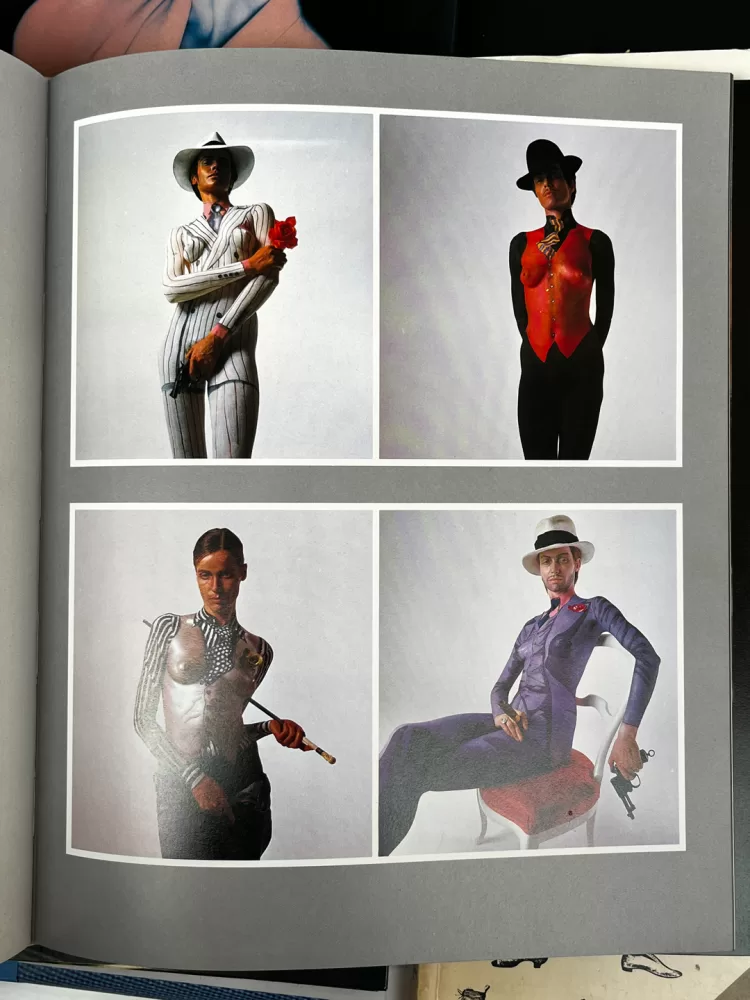 A photograph of a double-page spread from a photography book picturing a woman posing wearing body paint