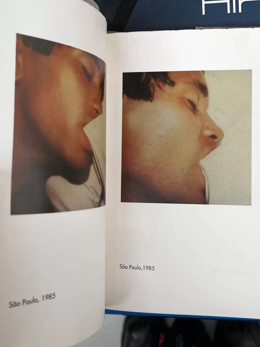 A photograph of a double-page spread from a photoraphy book picturing two photos of a man biting bedsheets