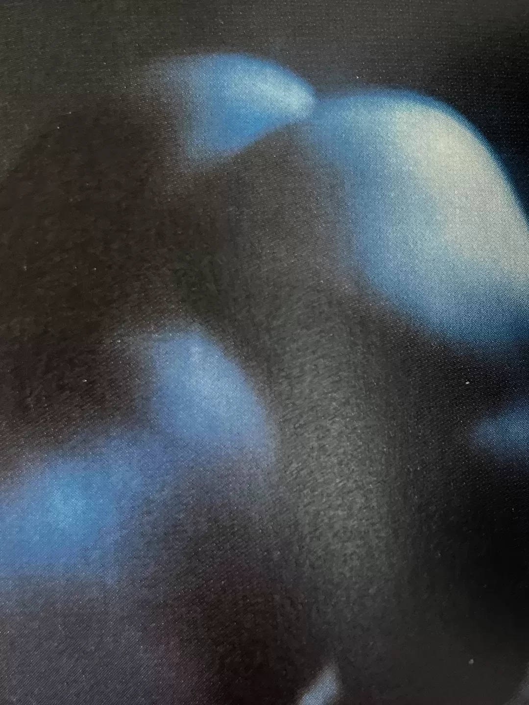 A photograph of a page from a photography book picturing a naked body bent over