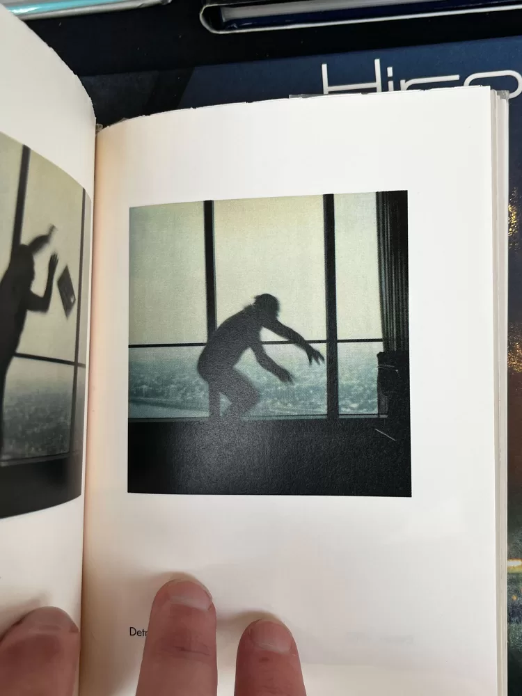 A photograph of a double-page spread from a photography book picturing someone jumping in the air