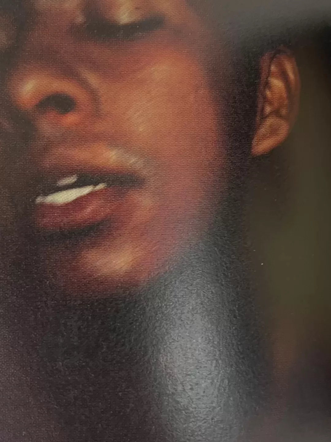 A photograph of a page from a photography book featuring a close-up portrait of someone with their eyes closed