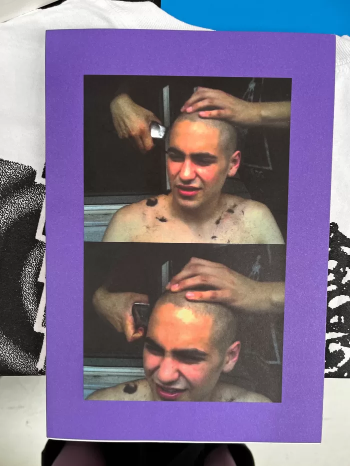 A photograph of the cover of TOPSAFE's 'Next To Nothing', picturing someone's hair being shaved