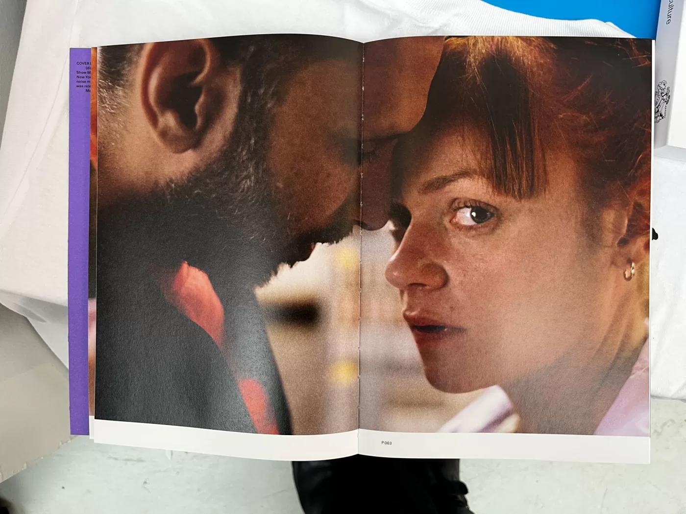 A photograph of a double-page spread from TOPSAFE's 'Next To Nothing', featuring a couple with their heads touching