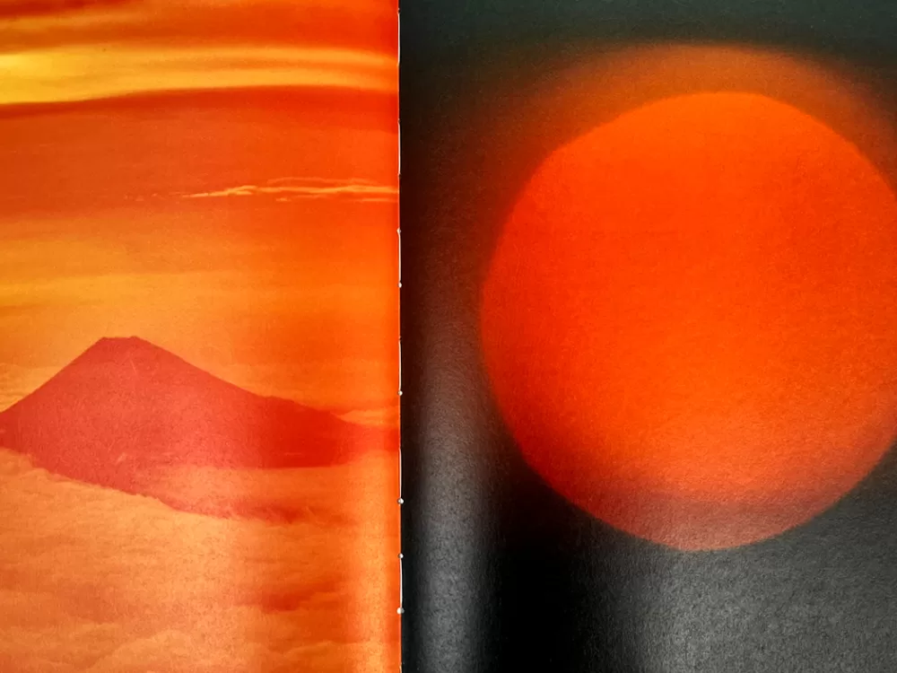 A photograph of a double-page spread from TOPSAFE's 'Next To Nothing', featuring two sunset photographs