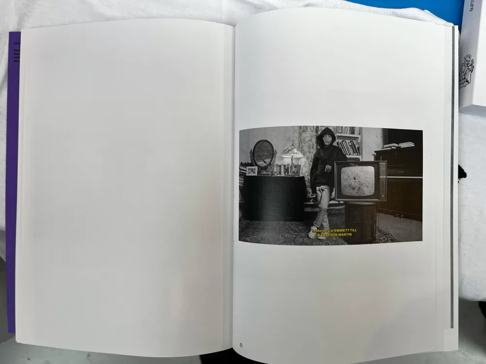 A photograph of a double-page spread from TOPSAFE's 'Next To Nothing', featuring a picture of someone stood reasting against a television in a living room