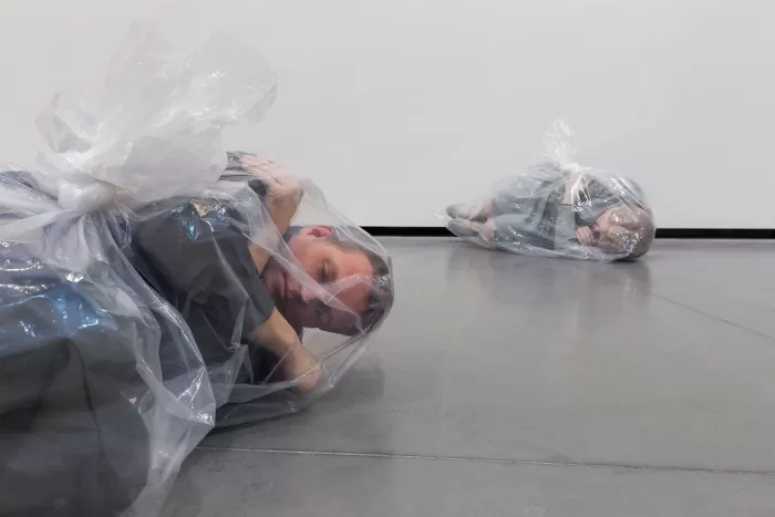 Installation view of Josh Kline's 3D printed sculptures of two people sealed in plastic bags, as part of the Louisiana Museum of Modern Art's exhibition about AI and art