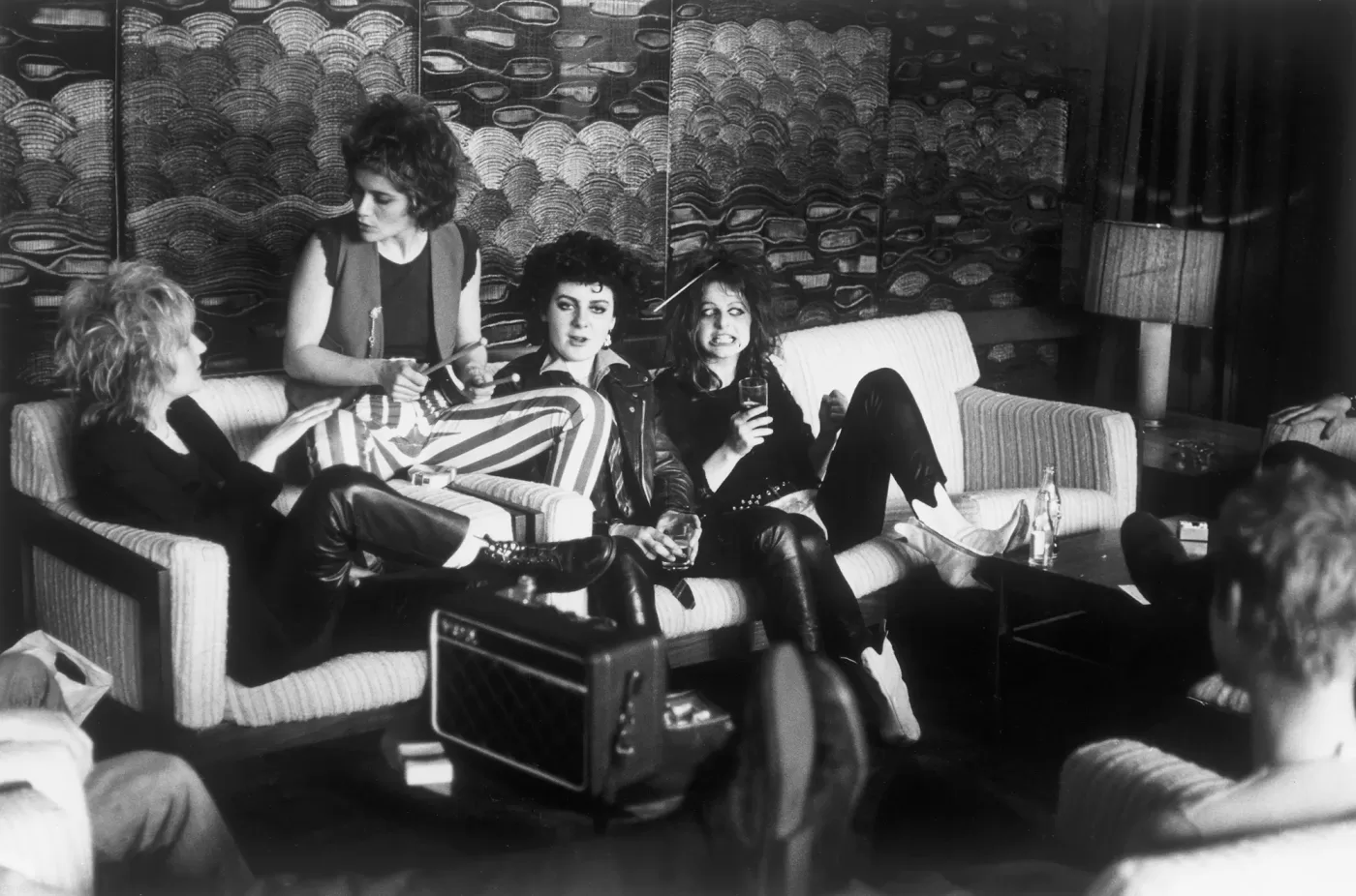 Black and white photograph of a group of women lounging on a sofa