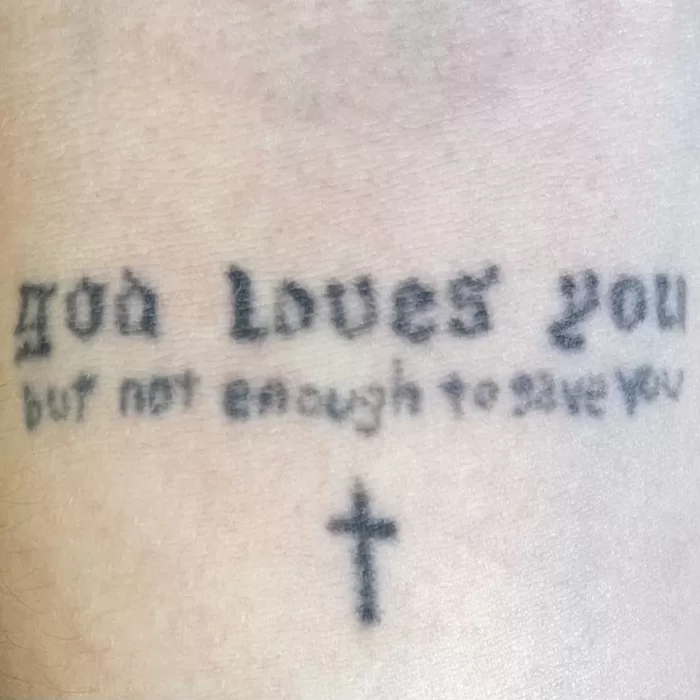 Ethel Cain's tattoo that reads 'god loves you but not enough to save you'