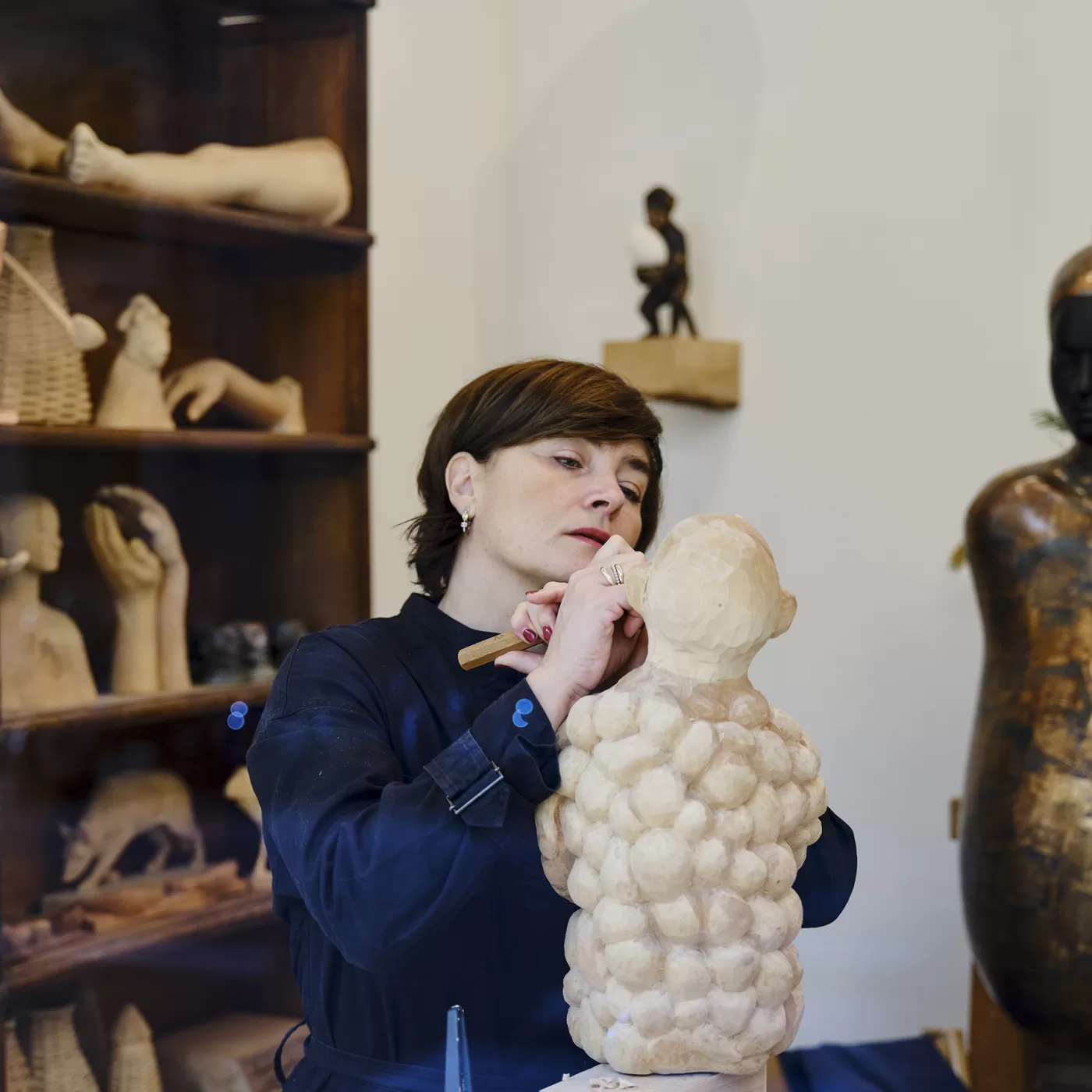 Paloma Varga Weisz photographed working on a figurative sculpture