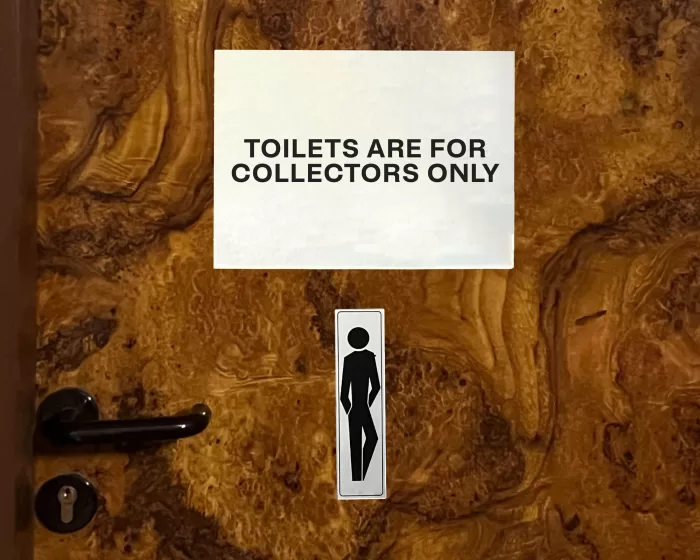 Picture of a graphic showing a toilet door with the sign "toilets are for collector's only"