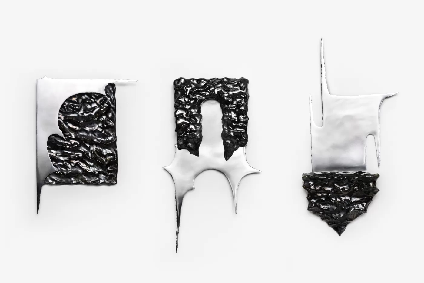 Karlina Mezecka's trio of steel sculptures coated in a black ceramic glaze