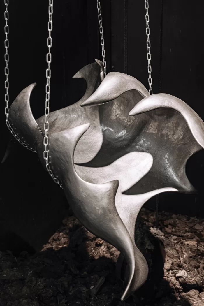 Karlina Mezecka's abstract industrial sculpture suspended with chains